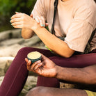 woman rubbing skin with mosquito repellent balm