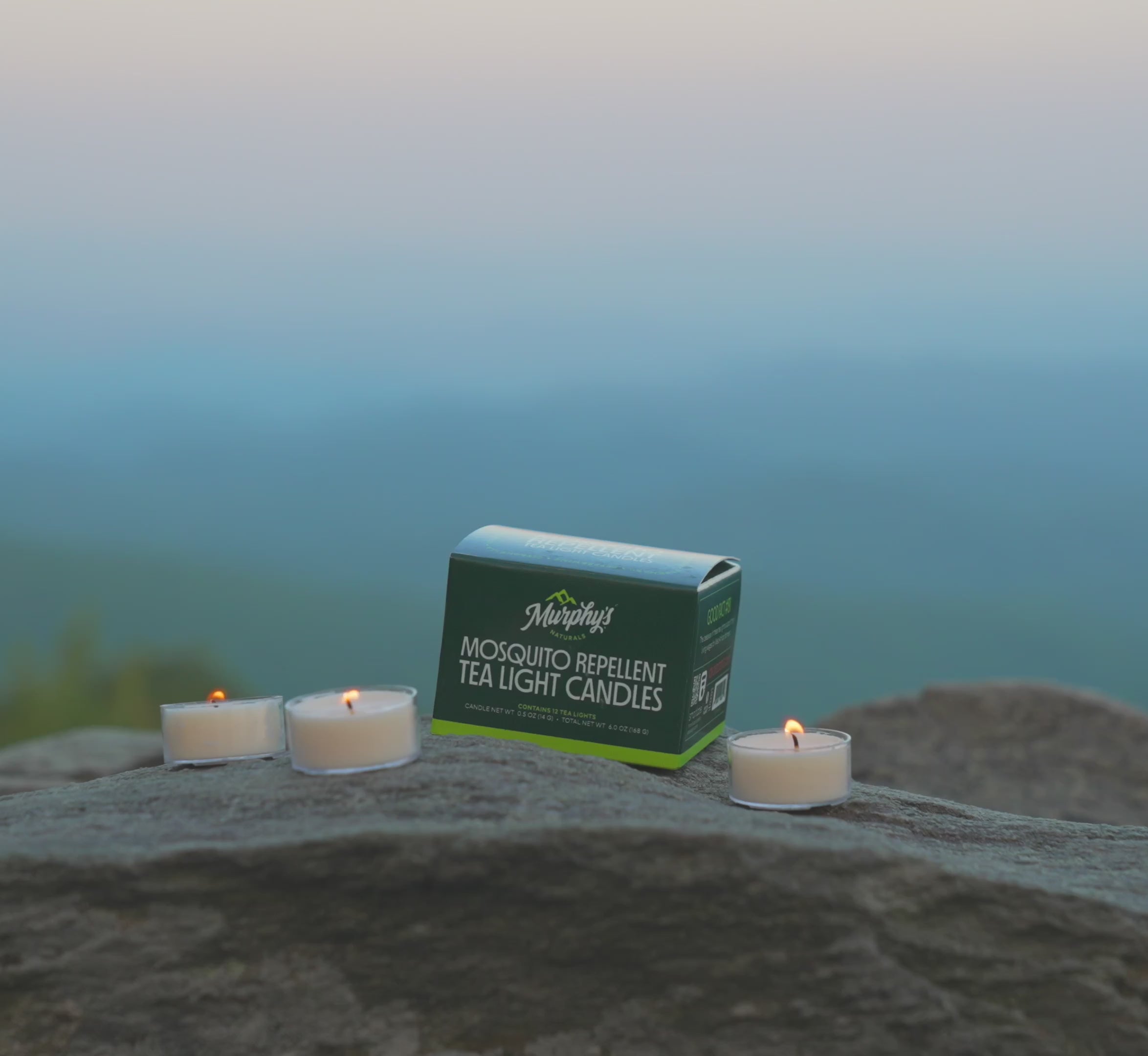 Tealights burning on a rock