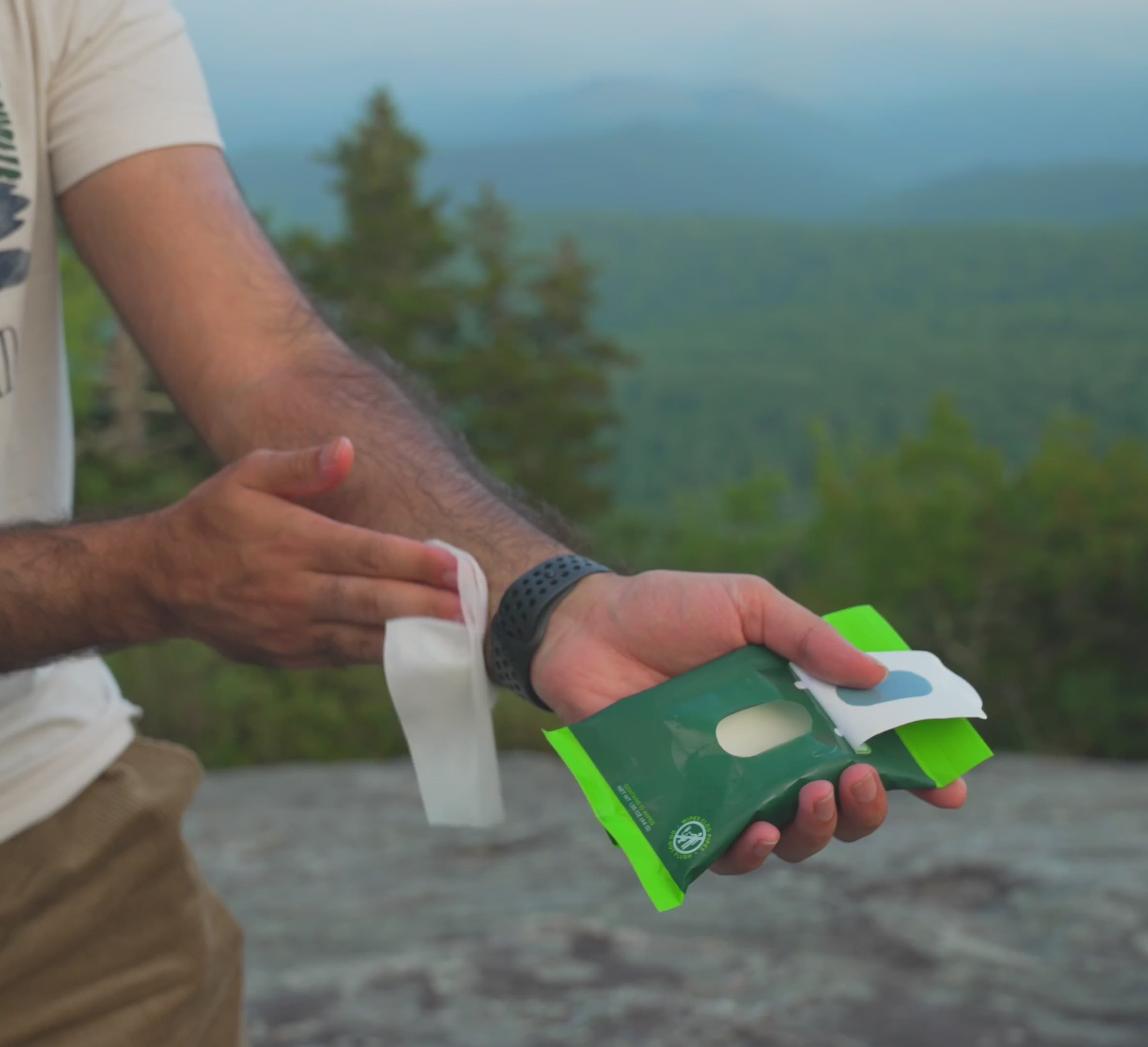 Wipes being taken out of package and applied to mans arm.