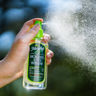 Lemon Eucalyptus Oil Mosquito Repellent Spray being sprayed with visible mist in the air