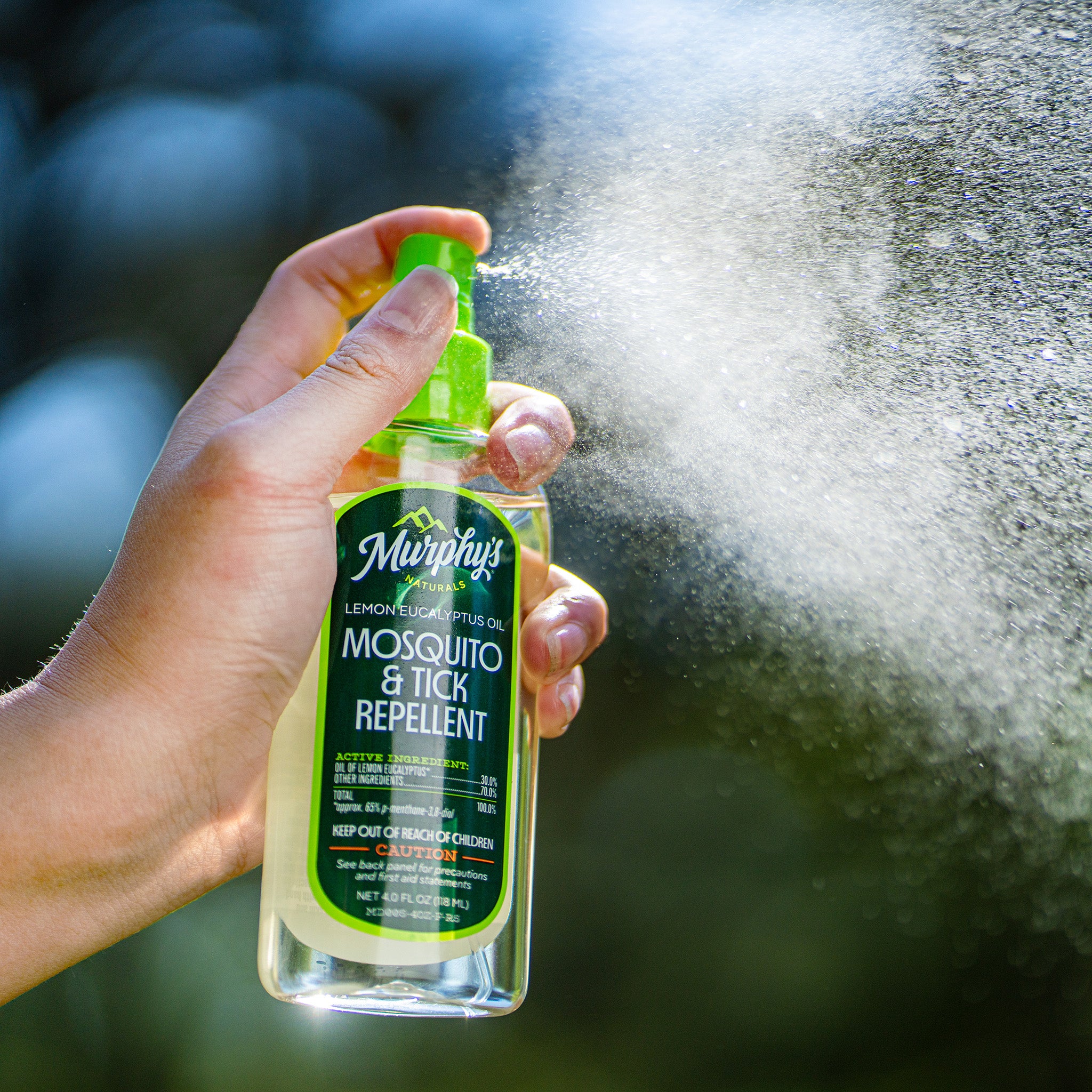 Lemon Eucalyptus Oil Mosquito Repellent Spray being sprayed with visible mist in the air
