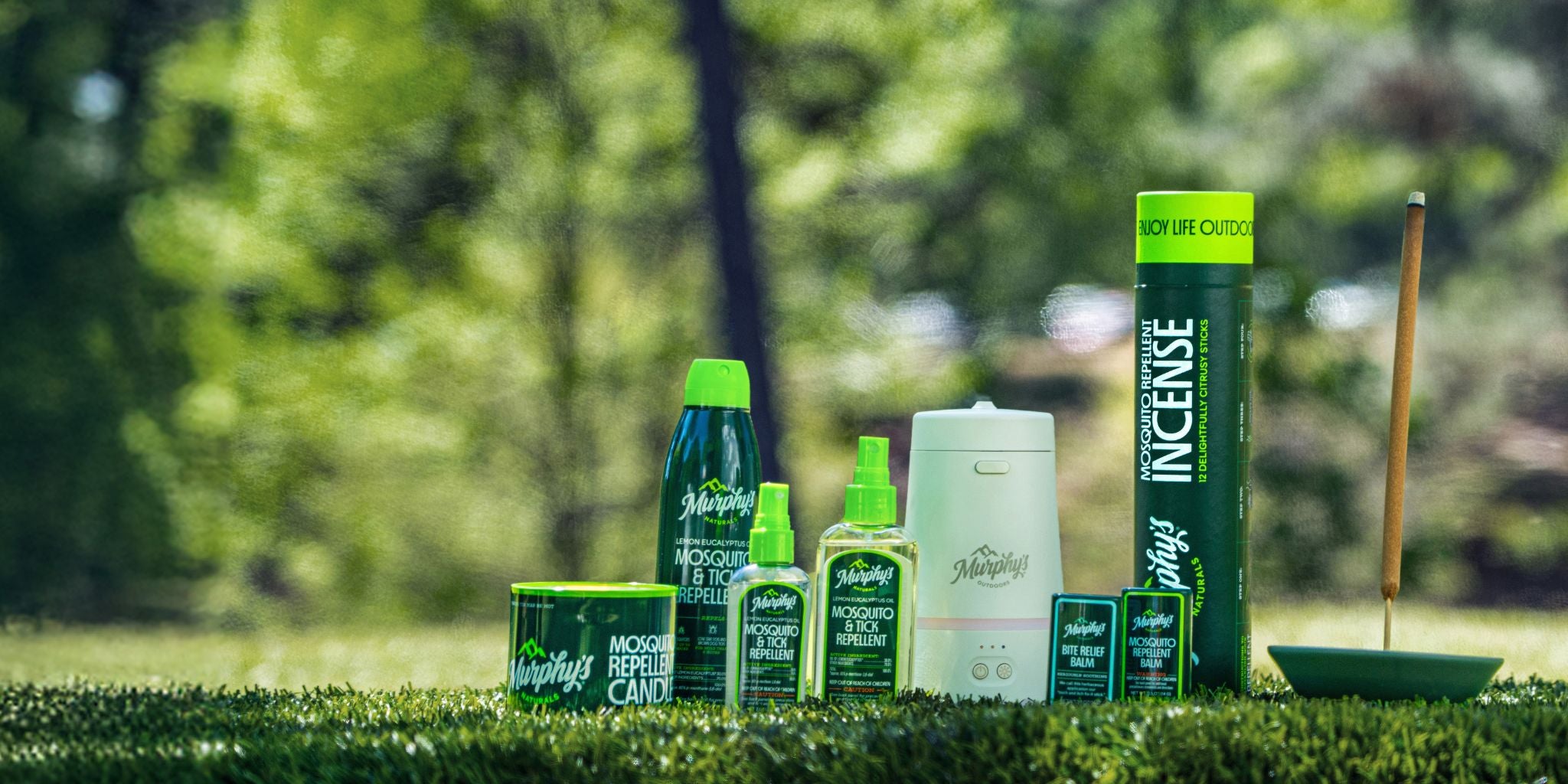 Murphy's Naturals products on grass in a park with a blurry background.